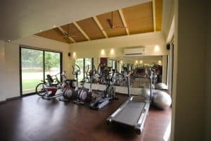 a treadmill and few bicycles in gym